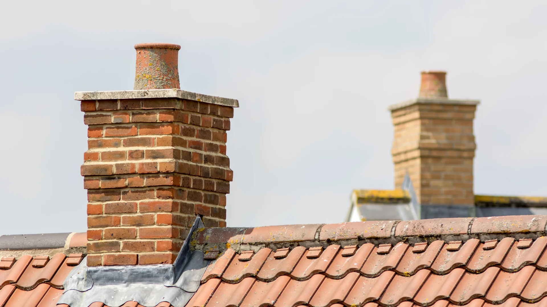 Stock image of brick chimneys and lead flashing for chimney repairs
